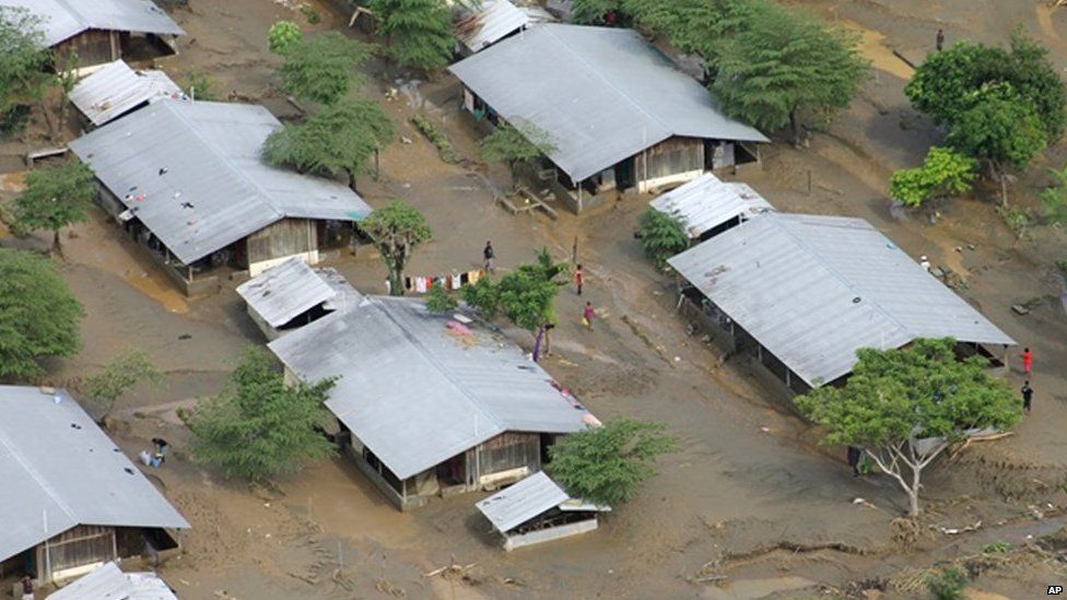 In this Saturday, 5 April, 2014 photo, buildings are surrounded by mud and flood waters on the Guadalcanal Plains, Solomon Islands