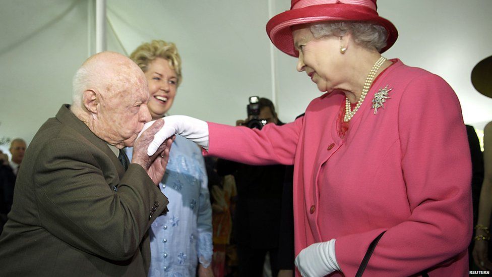 Actor Mickey Rooney kisses the hand of the UK's Queen Elizabeth II during a garden party celebrating her state visit to the US at the British embassy in Washington in May 2007