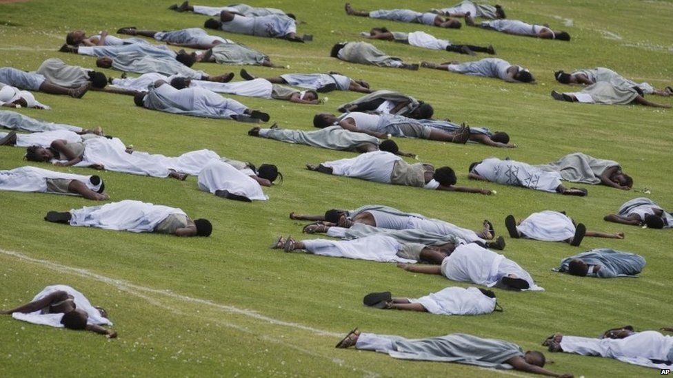 Performers re-enact the events at a public ceremony to mark the 20th anniversary of the Rwandan genocide at Amahoro stadium in Kigali, Rwanda, on 7 April 2014
