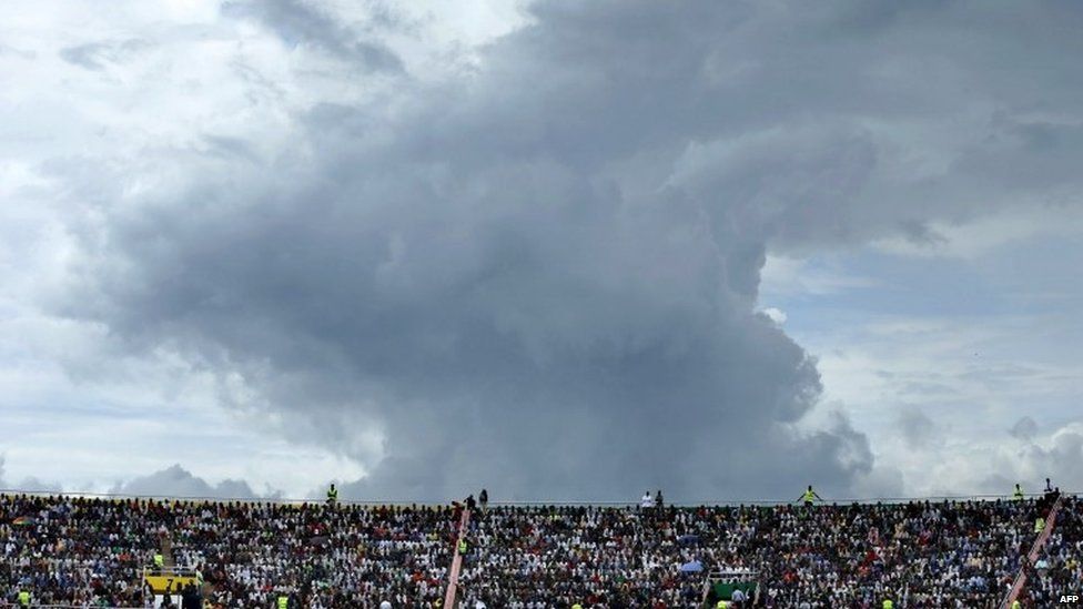The sky threatens rain as tens of thousands of people gather to commemorate the 20th anniversary the 1994 genocide at Amahoro Stadium on 7 April 2014 in Kigali, Rwanda