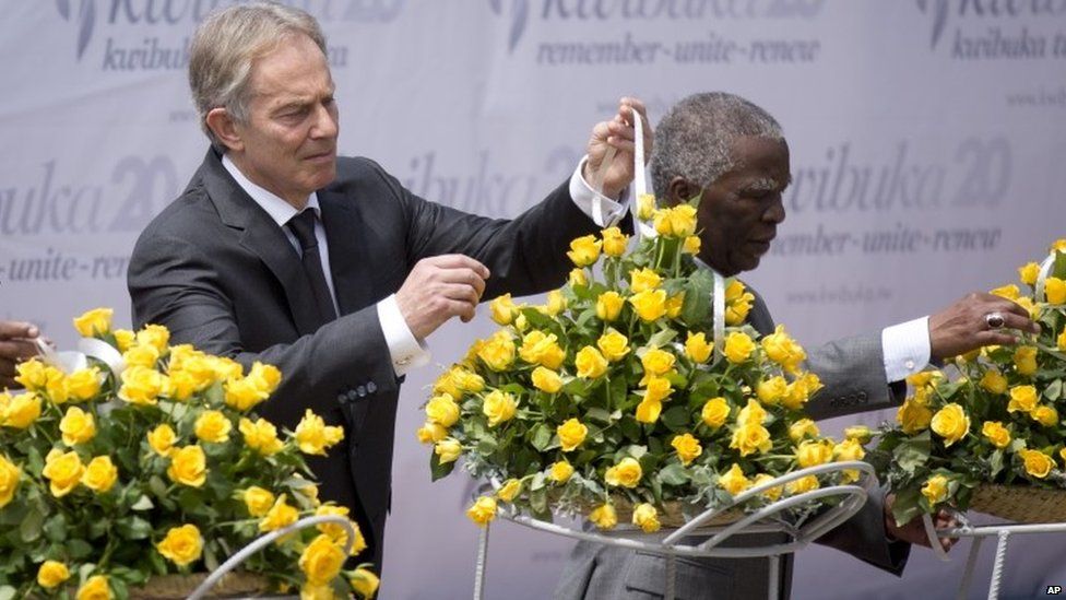 Tony Blair, left, and Thabo Mbeki, right, lay a memorial wreath at a ceremony to mark the 20th anniversary of the Rwandan genocide in Kigali on 7 April 2014