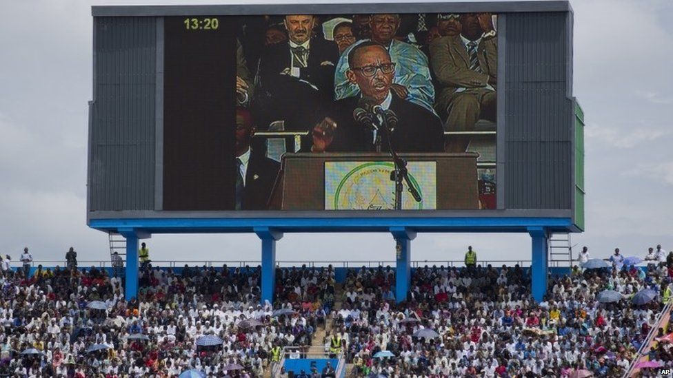 Rwandan President Paul Kagame, seen on a large television screen, addresses the public and dignitaries at a ceremony to mark the 20th anniversary of the Rwandan genocide, at Amahoro stadium in Kigali on 7 April 2014