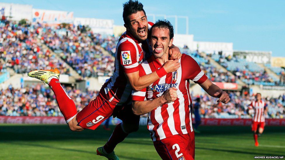 Atletico's Diego Godin celebrates his goal with teammate David Villa