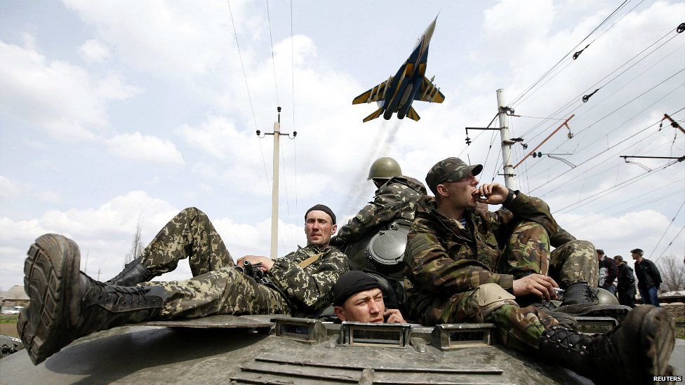 A Ukrainian fighter jet passes a convoy of Ukrainian soldiers that was brought to a halt by residents in Kramatorsk - 16 April 2014