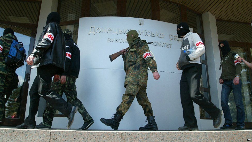 Armed members of Oplot, or "Stronghold" in Russian, enter a city administration building in Donetsk - 16 April 2014