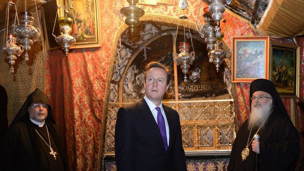 David Cameron (centre) during a visit to the Church of the Nativity in Bethlehem, on the second day of a trip to the Middle East designed to bolster efforts to rekindle the stalled peace process. PRESS ASSOCIATION Photo. Picture date: Thursday March 13, 2014