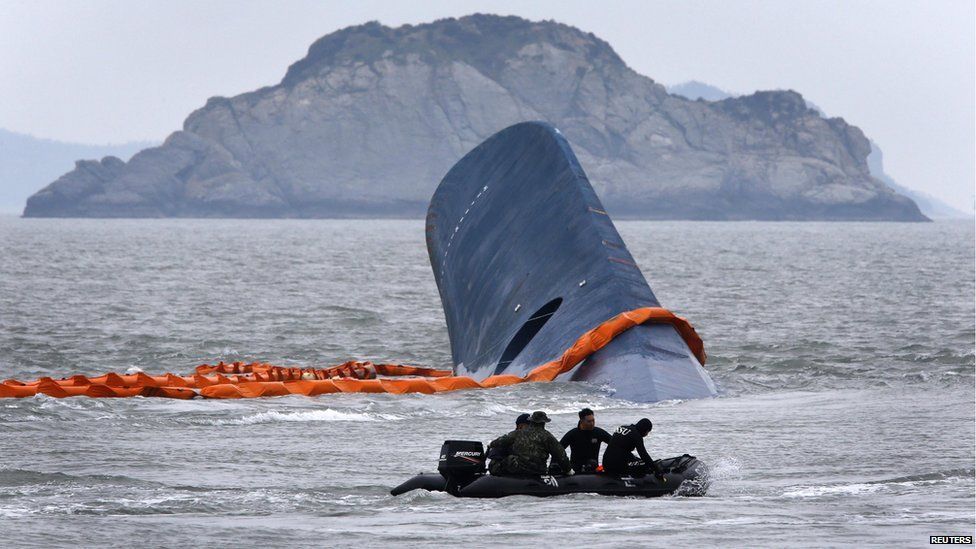 A vessel involved in salvage operations passes near the upturned South Korean ferry on 17 April 2014.