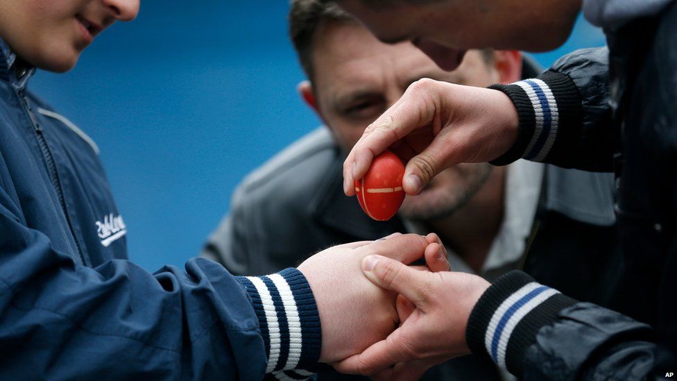 People take part in an egg-cracking contest in the village of Mokrin, 120km (75 miles) north of Belgrade, Serbia on 20 April 2014