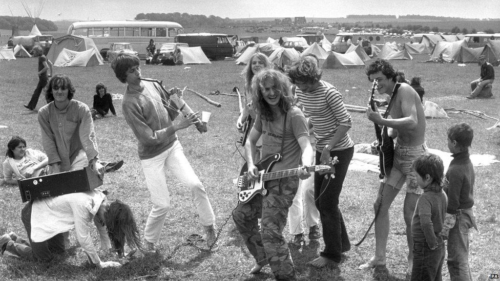 A group of musicians provide at entertainment at the Stonehenge Free Festival in 1980