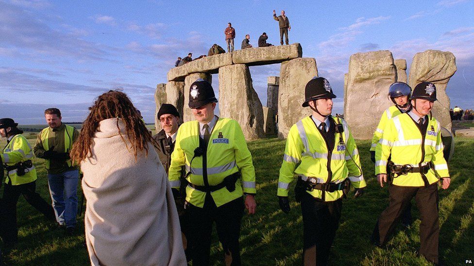 Police move to evict revellers at Stonehenge, Wiltshire, after a large number of people converged on the site during the celebration of the summer solstice in 1999.