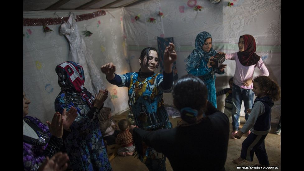 Female Syrian refugees dance around at a wedding celebration in a refugee camp in Marj El-Khokh, in Marjaayoun, Lebanon, March 6, 2014.
