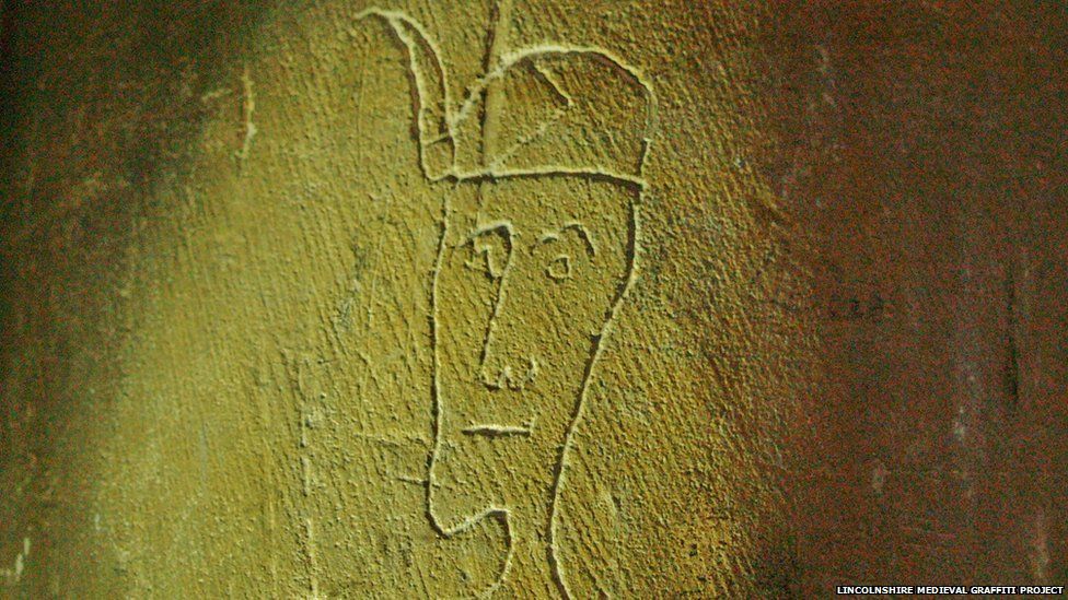 Head of a man etched into wall of a church in Lincolnshire