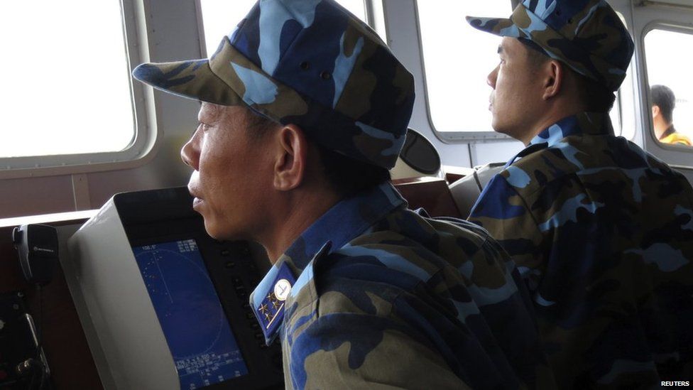 Crewmen aboard Vietnam coastguard ship 8003 look at a Chinese navy frigate on a screen, in disputed waters close to the Haiyang Shiyou 981, known in Vietnam as HD-981, oil rig in the South China Sea on 15 July, 2014