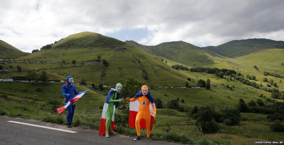 Spectators wait for the riders at Peyeresourde pass during the 17th stage of the Tour de France cycling race in France
