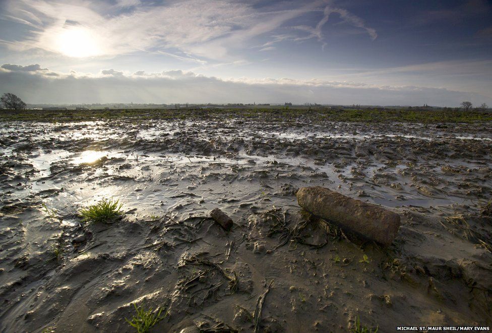 An unexploded shell lies amid the mud of Passchendaele