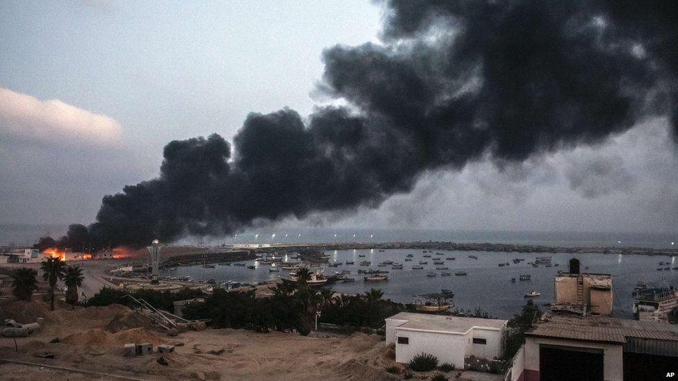 A building within the Gaza port is seen on fire after several strikes early on July 29, 2014.