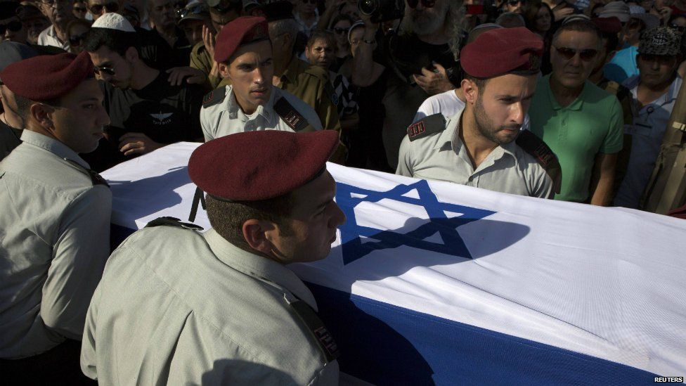 Israeli soldiers carry the coffin of their comrade Liad Lavi, who died after succumbing to wounds he sustained last week while fighting in Gaza - 28 July 2014