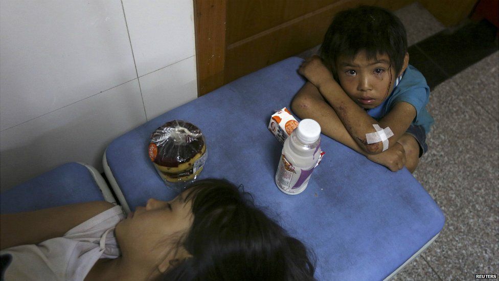 A boy cries next to his sister at a hospital after they were both injured by the earthquake in Yunnan province - 3 August 2014