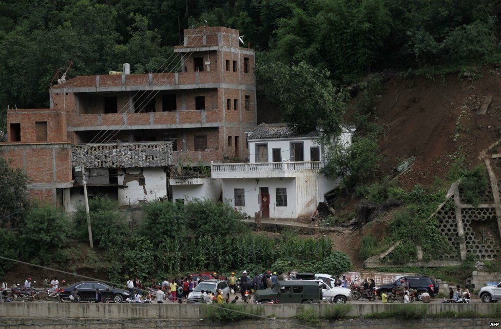 Residents gather near damaged houses following the earthquake in Yunnan province - 3 August 2014