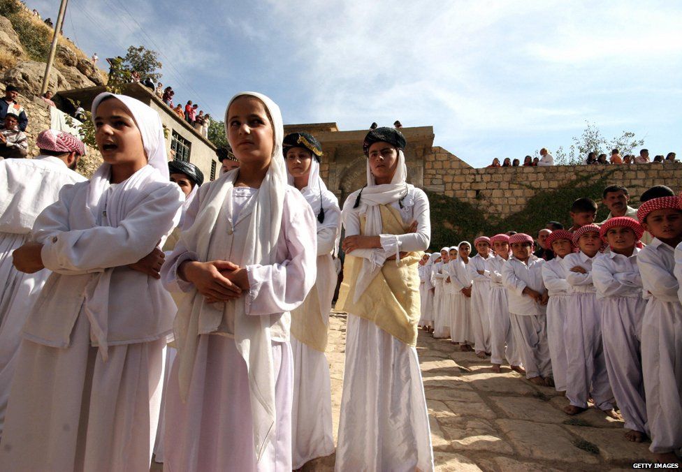 Girls and boys from a Yazidi religious school sing hymns and prayers