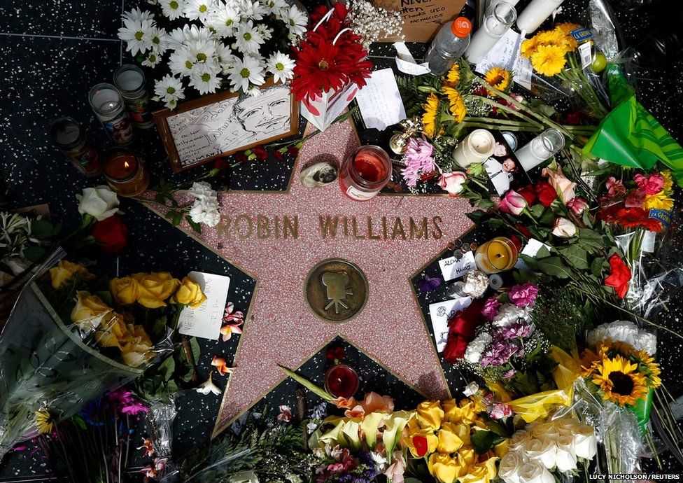 Flowers are seen on the late Robin Williams' star on the Hollywood Walk of Fame in Los Angeles