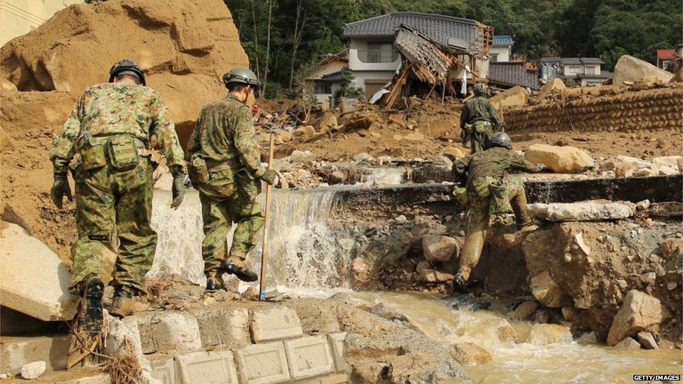 Members of Japan's Ground Self-Defense Force continue the search for missing people among the debris