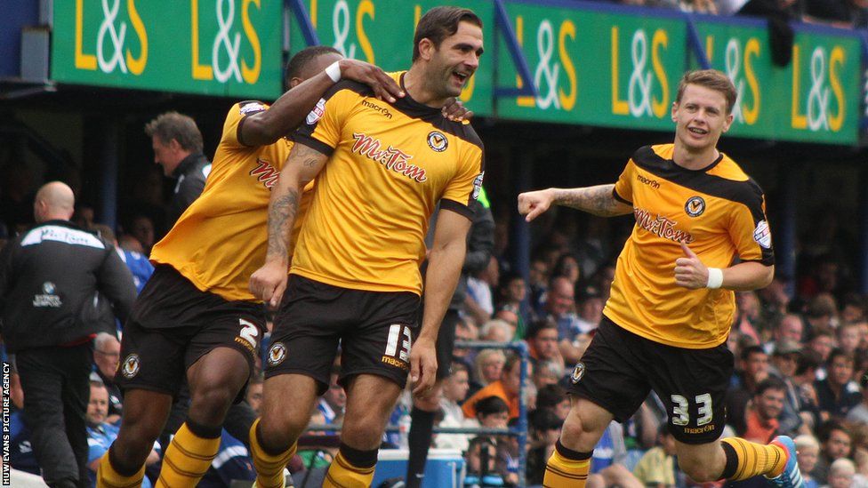 Andy Sandell celebrates with team mates Ryan Jackson and Mark Byrne after scoring Newport County's winning goal against Portsmouth.