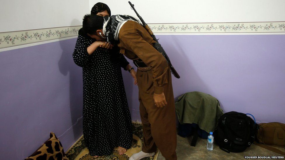 A mother says goodbye to her son in Tuz Khurmatu, Iraq