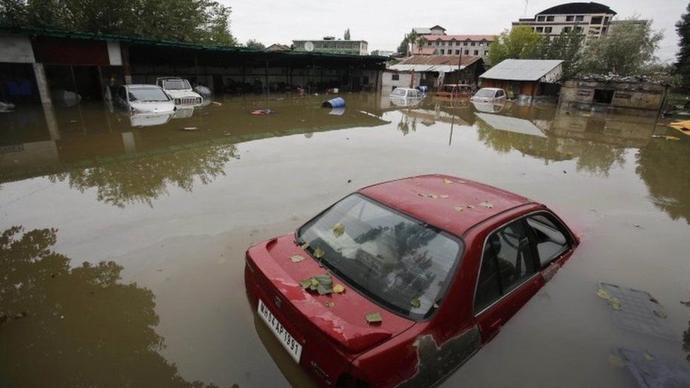 Vehicle are partially submerged in flood waters in Srinagar, India, Sunday, Sept.7, 2014