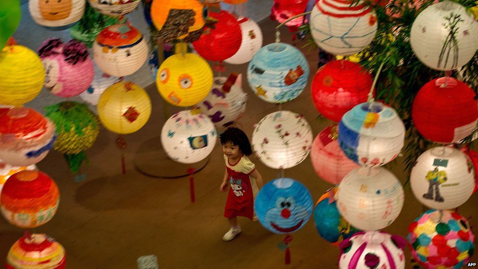 A Malaysian child plays amidst Chinese lanterns displayed at a mall ahead of the Mid-Autumn Festival celebrations in Kuala Lumpur on 7 September, 2014