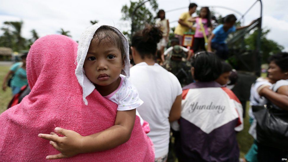 Filipino villagers living near restive Mayon Volcano arrive in a public school turned into a temporary evacuation in Guinobatan town, Albay province, Philippines, on 17 September 2014