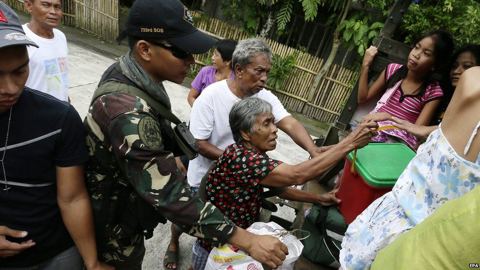 A Filipino soldier assists an elderly to board a military truck during an evacuation of residents living near the restive Mayon Volcano in Guinobatan town, Albay province, Philippines on 17 September 2014