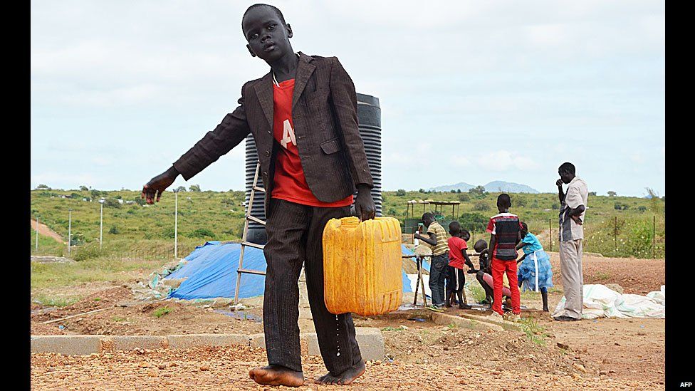 A South Sudanese boy carrying a jerry can of water, Juba, South Sudan - Wednesday 17 September 2014