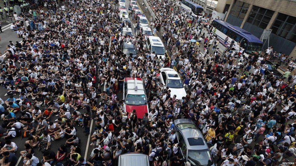 Tens of thousands of protesters block traffic on the main road leading to the financial Central district outside the government headquarters in Hong Kong on 28 September, 2014