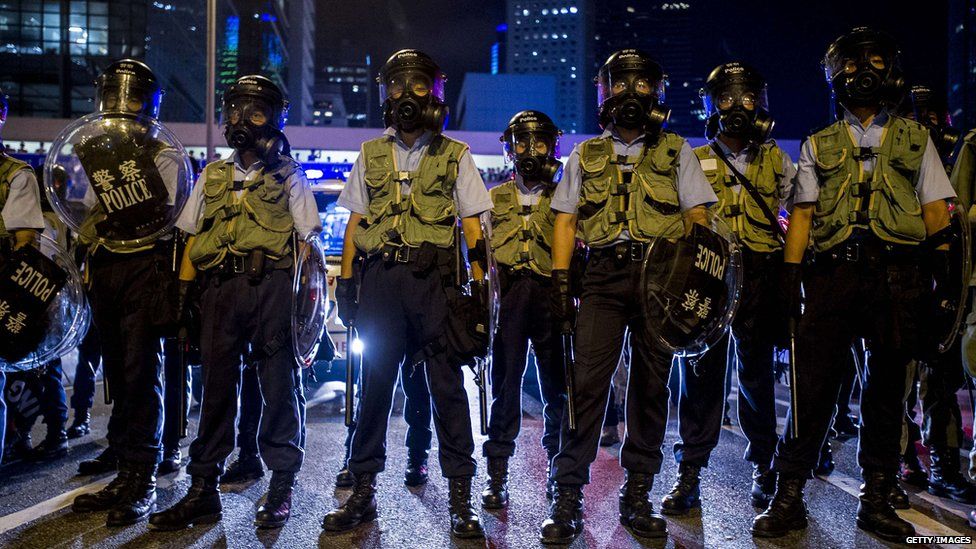 Police officers stand guard during clashes with pro-democracy protesters in Hong Kong on 28 September 2014.