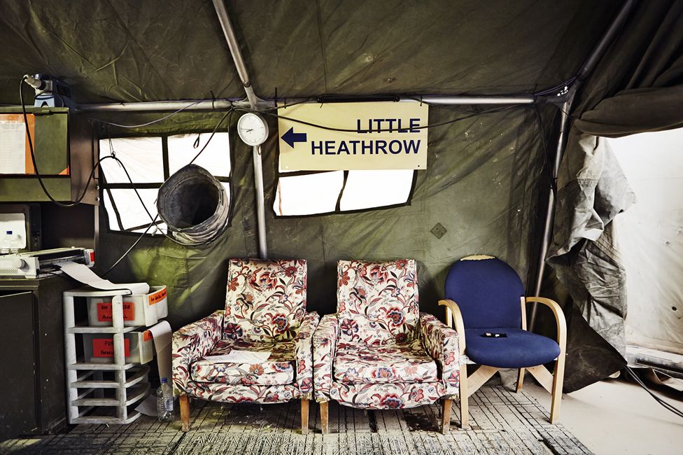 Armchairs and a sign that reads "Little Heathrow".