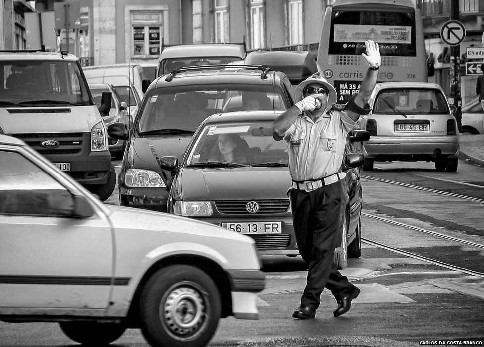 Traffic warden dancing in the street in Lisbon