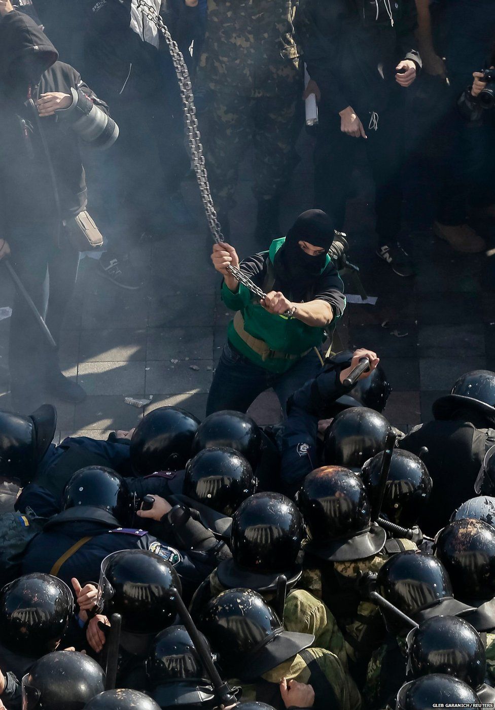 A protester clashes with law enforcement officers on the Day of Ukrainian Cossacks in Kiev