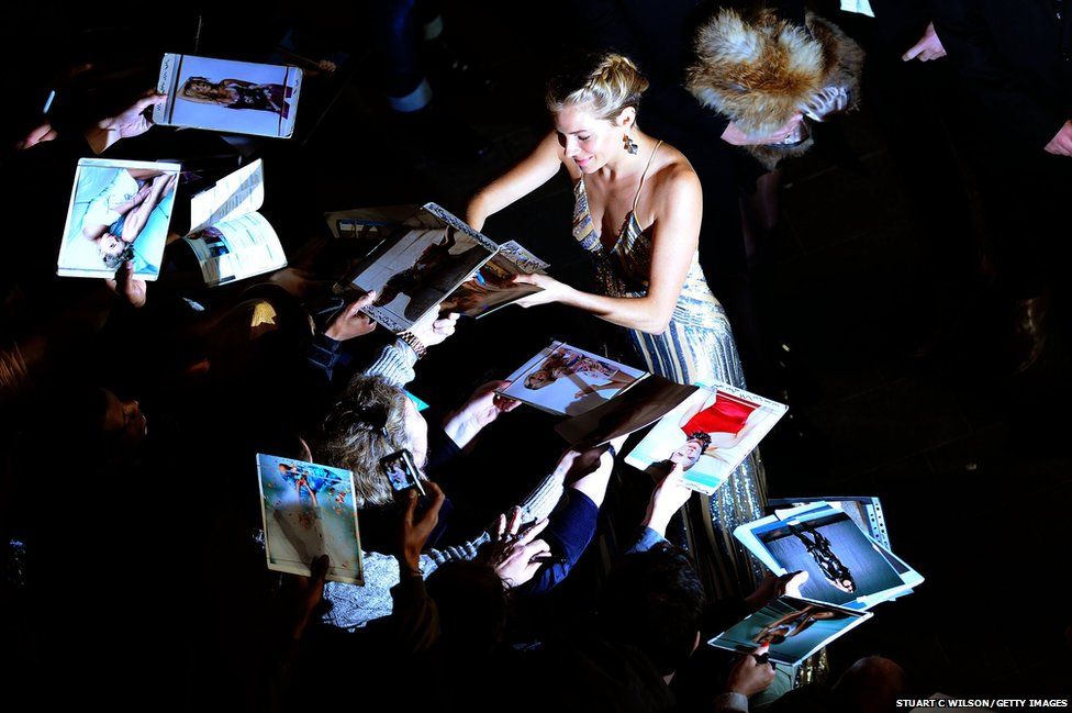 Actress Sienna Miller signs autographs
