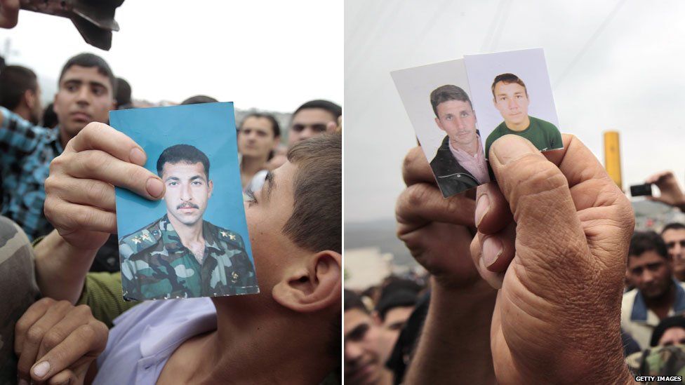 Syrians hold up pictures of missing relatives