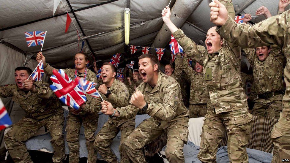 Gunners from the British Army's 32 Regiment Royal Artillery watch the London 2012 Olympics from Camp Bastion, in August 2012