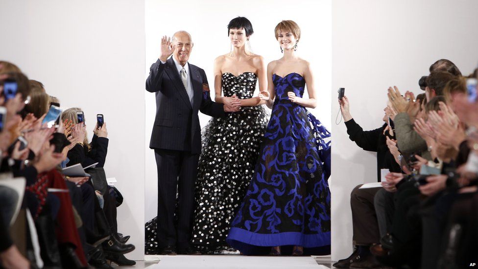 Oscar de la Renta waves to the crowd as he debuts his Fall 2014 collection at New York Fashion Week in February this year