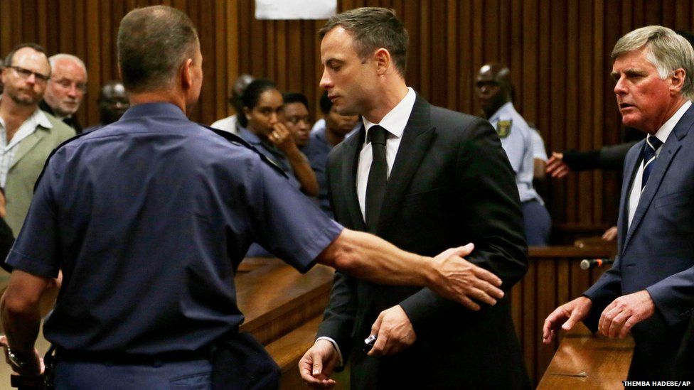 Oscar Pistorius (centre) is led out of court in Pretoria, South Africa