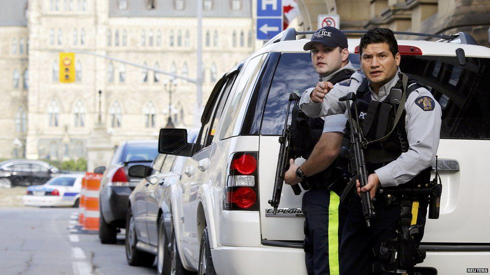 Armed RCMP officers guard access to Parliament Hill in Ottawa