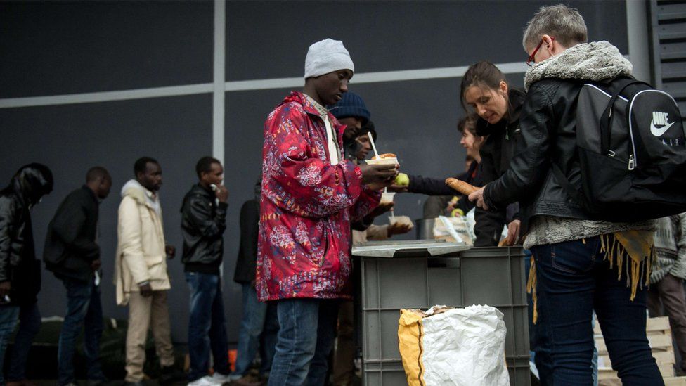 People queue for food in Calais