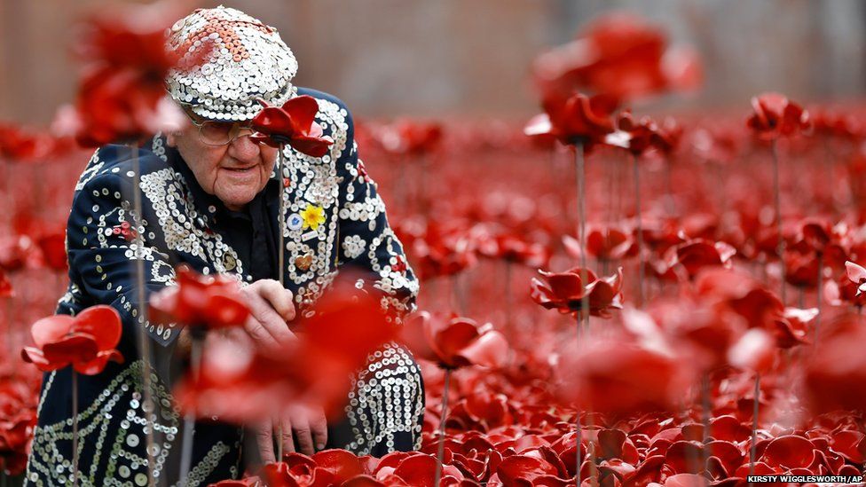 Harry Mayhead, Pearly King of Bow Bells who served in Egypt and France for the Royal Army Service Corp. in World War Two, plants poppies at the Tower of London (19 September2014)