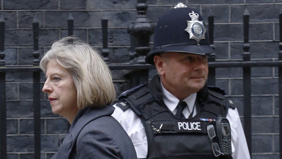 Theresa May with a police officer