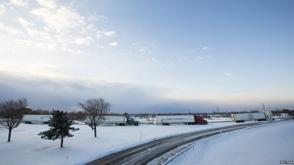Trucks sit stranded in the heavy snow that has hit the US