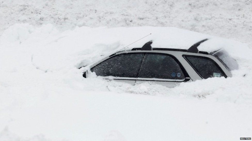 A car is submerged by snow in the US