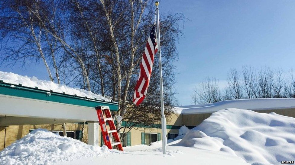 Snow reaches far up a flagpole in the US